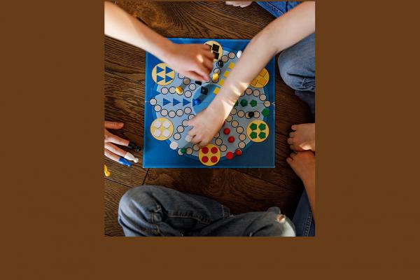 children's hands across a board game