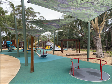 Playground equipment under shade sails at Mary Carroll Park