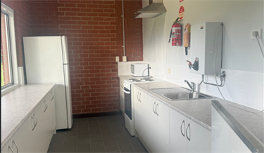 Kitchen with benches fridge urn and oven
