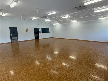 Inside Southern River Hall with timber parquetry flooring and fluorescent lighting