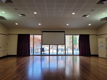 Hall showing roll down screen and courtyard in background