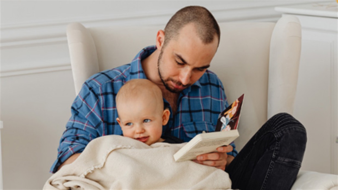 Dad reading to baby