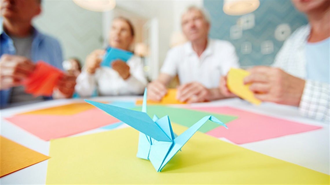 origami bird with people in the background.jpg