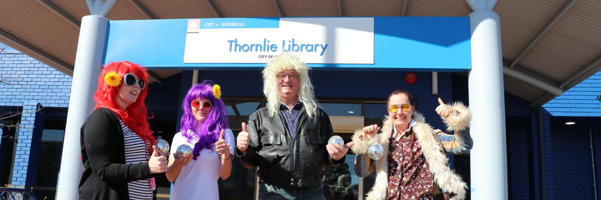 Image of Mayor with Library staff dressed up in 1970s clothes