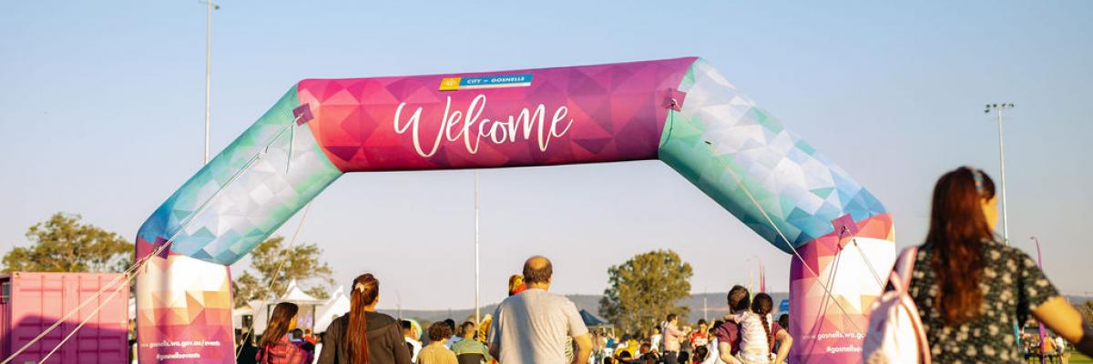 People walking under the welcome arch at Fusion Festival