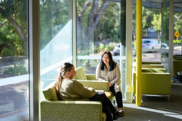 People sitting on lounges by the windows in Knowledge Centre