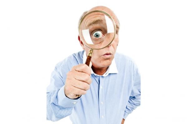 a man using a magnifying glass