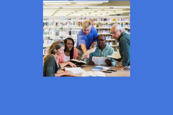 five people looking at books in a library