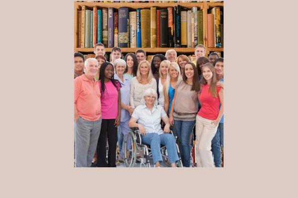 A group of people in front of book shelves