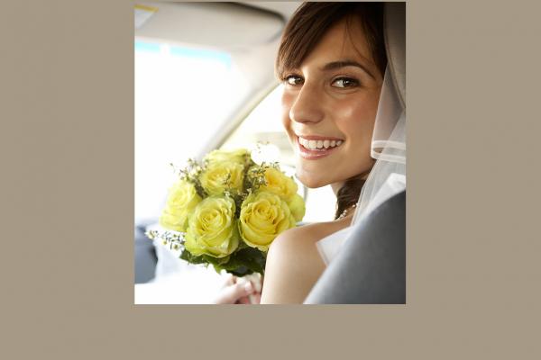 Bride with bouquet in a car