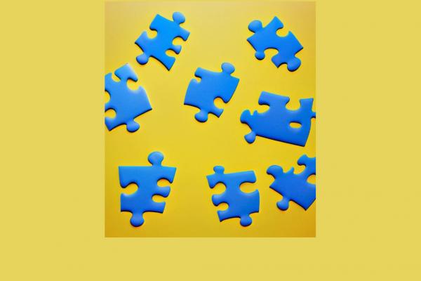 blue jigsaw pieces on a yellow background