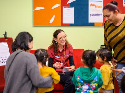 Image of library staff member interacting with children