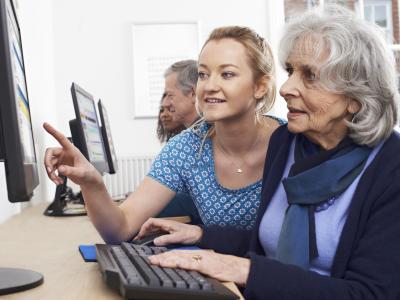 Image of senior getting help on computer