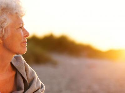 Senior woman looking at the sunset 