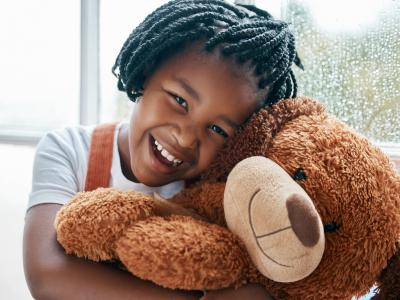 African girl with teddy bear