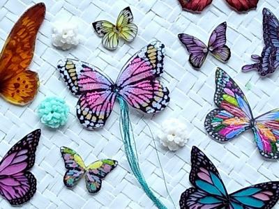 A number of colourful butterfly shaped ornaments or charms that have been crafted by hand.