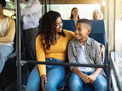 A mother and son ride the bus