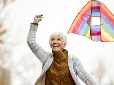 Senior Woman flying kite
