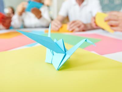 Blue paper origami crane on table