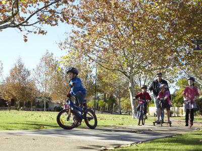 Family riding bikes in park