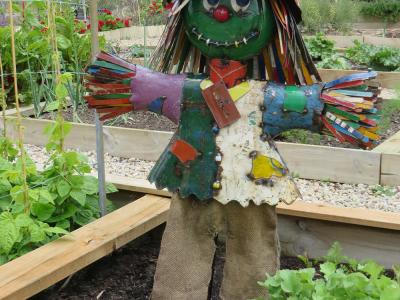 Scarecrow sculpture in the Community Garden
