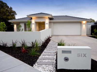 A home in the suburbs with letterbox and front fence